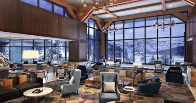 a large lobby with couches and chairs and windows at Everline Resort & Spa Palisades- Valley View in Olympic Valley