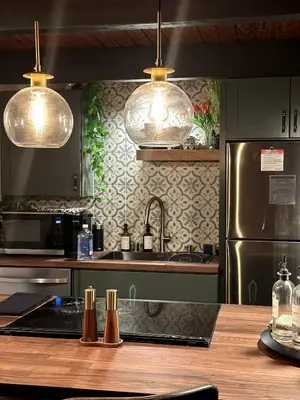 a kitchen with two pendant lights and a counter top at Sequoia A-frame Nirvana: Modern + Views + Hot Tub in Ponderosa