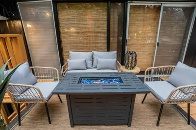 a table and two chairs on a patio at Sequoia A-frame Nirvana: Modern + Views + Hot Tub in Ponderosa