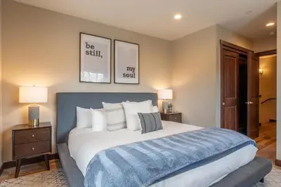 a bedroom with a large bed and two lamps at Mountainside 14 in Mammoth Lakes