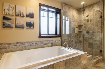 a bathroom with a tub and a glass shower at Mountainside 14 in Mammoth Lakes