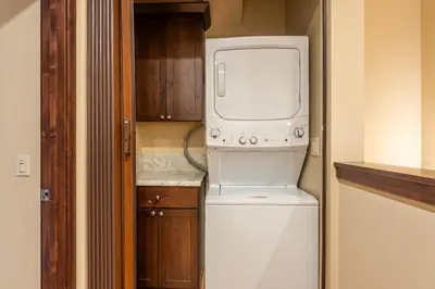 a microwave sitting on top of a refrigerator in a kitchen at Mountainside 14 in Mammoth Lakes
