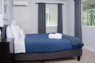a bedroom with a bed with blue sheets and pillows at Family Friendly 1st Apple Hill exit Tahoe in Placerville