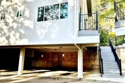 a building with a garage with stairs and a balcony at Family Friendly 1st Apple Hill exit Tahoe in Placerville