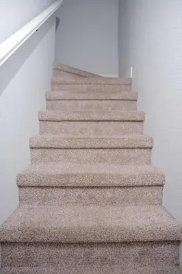 a staircase with beige carpeted stairs in a house at Enjoy the outdoors 1st Apple hill exit Tahoe in Placerville