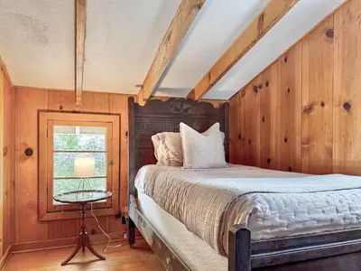 a bedroom with a bed and a window at Homestead Ranch near Yosemite with Horses and Chickens in Midpines