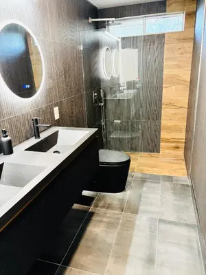 a bathroom with a sink and a toilet and a mirror at Experience Serenity Luxe 4BDR Lake House 25ft Pool in Elk Grove