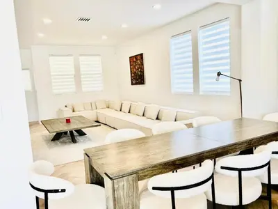 a living room with a table and chairs at Experience Serenity Luxe 4BDR Lake House 25ft Pool in Elk Grove