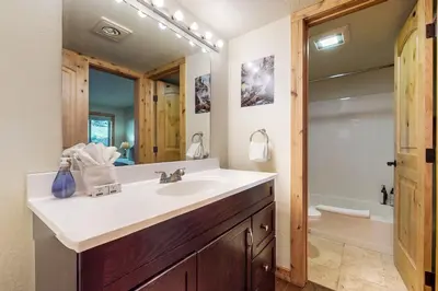 a bathroom with a sink and a toilet and a mirror at Basecamp Bliss in Olympic Valley