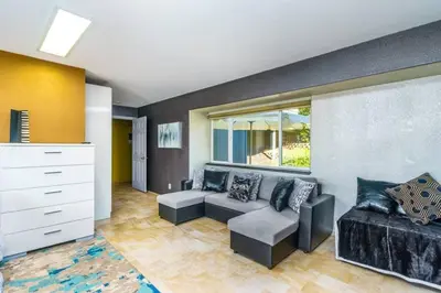 a living room with a couch and a chair at Massive 8 bedroom on the lake in Groveland