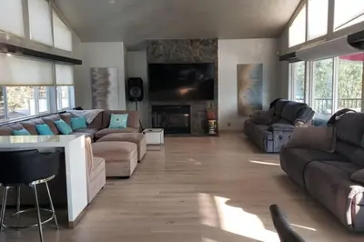 a living room with a couch and a fireplace at Massive 8 bedroom on the lake in Groveland
