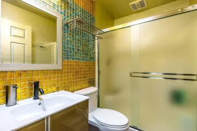 a bathroom with a toilet and a sink and a shower at Massive 8 bedroom on the lake in Groveland