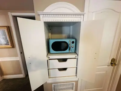 a microwave sitting on a shelf in a closet at Pinkie's Suite -Hot Tub-BBQ-views in Ahwahnee