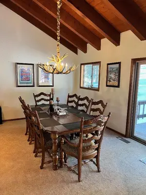 a dining room with a table and chairs and a chandelier at Serene Vistas at Northstar in Truckee