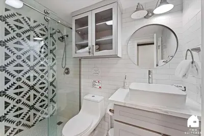 a bathroom with a toilet and a sink and a mirror at #LazyBear Tahoe Dreamy Escape in Tahoe Vista