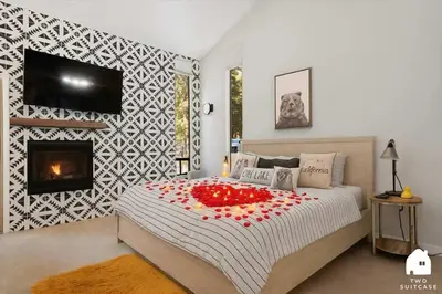 a bedroom with a large bed with a fireplace at #LazyBear Tahoe Dreamy Escape in Tahoe Vista