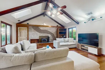 a living room with two couches and a flat screen tv at Deer Paradise in Coarsegold