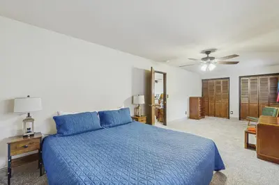 a bedroom with a blue bed and a ceiling fan at The Garden Haus in Incline Village