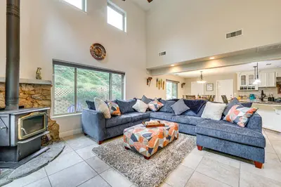 a living room with a blue couch and a fireplace at Hot Tub, Games and Sports Luxury Yosemite Escape in Oakhurst