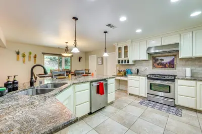 a kitchen with white cabinets and a sink at Hot Tub, Games and Sports Luxury Yosemite Escape in Oakhurst