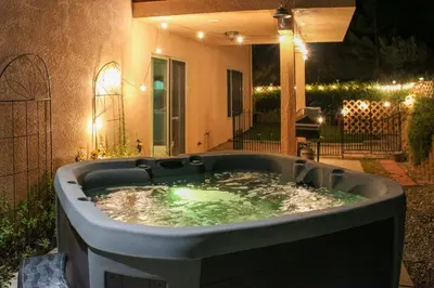 a jacuzzi tub in a backyard at night at Hot Tub, Games and Sports Luxury Yosemite Escape in Oakhurst