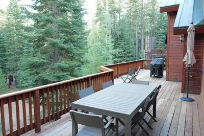 a wooden deck with a table and chairs on it at Modern Retreat in Truckee with AC and Game Room in Truckee