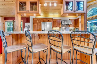 a kitchen with three chairs at a bar at Modern Retreat in Truckee with AC and Game Room in Truckee