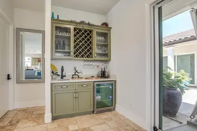 a kitchen with green cabinets and a window at 8 Mi to Lodi Lake Luxe Home with On-Site Vineyard in Acampo