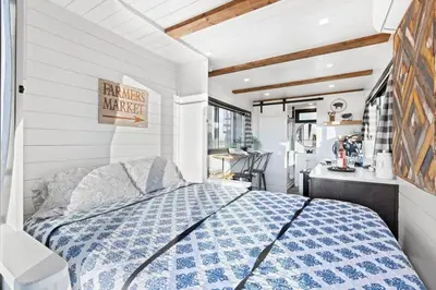 a bedroom with a blue and white bed in a room at Rooftop Spa Tiny Cargo Home Farm Experience in Tulare