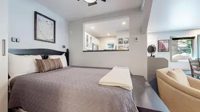a bedroom with a bed with a mirror and a chair at Hidden Valley #41 condo in Mammoth Lakes