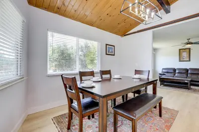 a dining room with a table and chairs and a couch at 4 Mi to Folsom Lake Modern Home with Patio! in Granite Bay