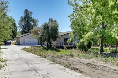 a house on the side of a road with trees at 4 Mi to Folsom Lake Modern Home with Patio! in Granite Bay