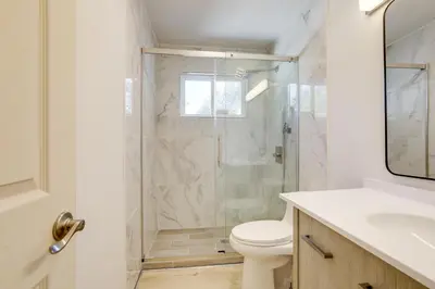 a bathroom with a shower with a toilet and a sink at 4 Mi to Folsom Lake Modern Home with Patio! in Granite Bay