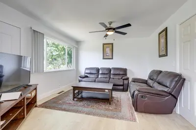 a living room with leather furniture and a flat screen tv at 4 Mi to Folsom Lake Modern Home with Patio! in Granite Bay
