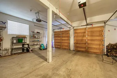 a garage with wooden doors in a room at Jackpine Lodge at Tahoe Donner by Tahoe Getaways - Private Hot Tub w Foosball and HOA in Truckee