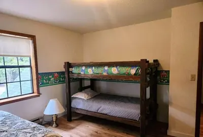 a bedroom with two bunk beds and a lamp at Relax Inn - Close to Attractions Galore in Truckee