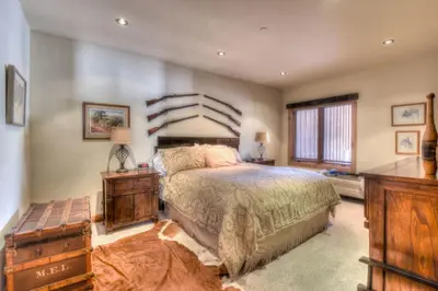 a bedroom with a large bed and a large window at Ridge Court Barrel - Relax in Private Hot Tub in Olympic Valley