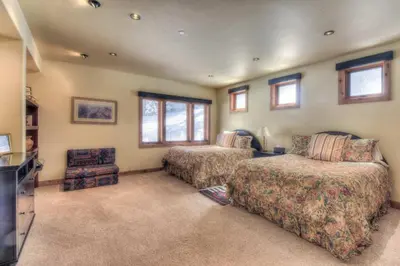 a bedroom with two beds and a couch and a tv at Ridge Court Barrel - Relax in Private Hot Tub in Olympic Valley