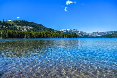 a large body of water with mountains in the background at Ridge Court Barrel - Relax in Private Hot Tub in Olympic Valley