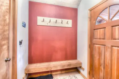a hallway with a red wall and a door at Relax at Rustic Tahoe Charm - Minutes to Lake in Tahoma