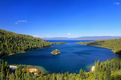 an island in a lake in the middle of a forest at Relax at Rustic Tahoe Charm - Minutes to Lake in Tahoma