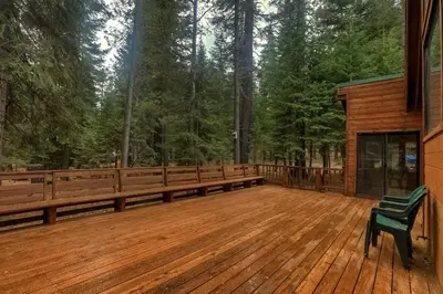 a large wooden deck with a bench on it at Serenity at Tahoe Donner with Large Balcony in Truckee