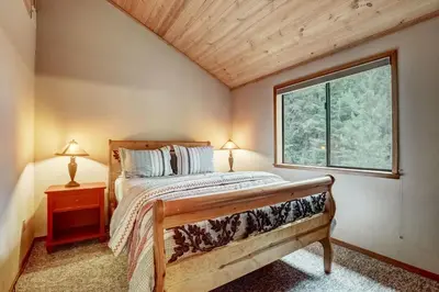 a bedroom with a bed and a window at Serenity at Tahoe Donner with Large Balcony in Truckee