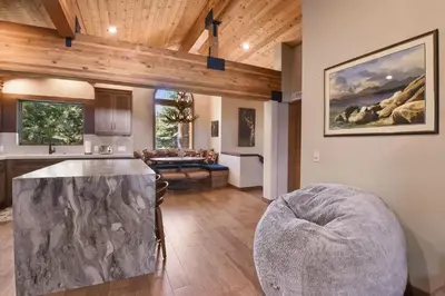 a kitchen and a living room with a table at Shoreline Vista - Lake Views Near Hike & Bike in Carnelian Bay