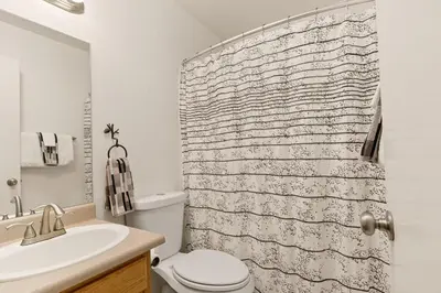 a bathroom with a toilet and a shower curtain at Sierra Pines Retreat - Sleeps 6 in Incline Village