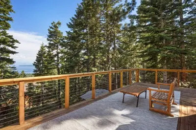 a wooden deck with a table and chairs on it at Snowshoe Cabin - 3 Decks BBQ & Hot Tub in Tahoe City
