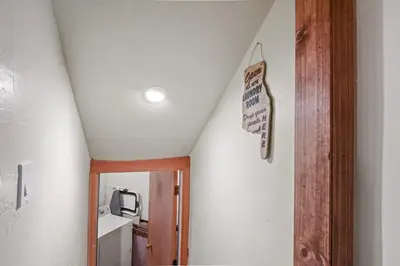 an attic room with a staircase with a sign on the wall at Snowshoe Cabin - 3 Decks BBQ & Hot Tub in Tahoe City