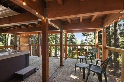 a screened in porch with four chairs and a table at Snowshoe Cabin - 3 Decks BBQ & Hot Tub in Tahoe City