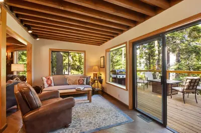 a living room with a couch and a table at Snowshoe Cabin - 3 Decks BBQ & Hot Tub in Tahoe City