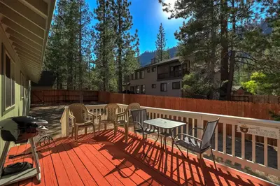 a patio with chairs and a table on a deck at Tahoe Frost - Air conditioned 4 bedroom Tahoe home in South Lake Tahoe